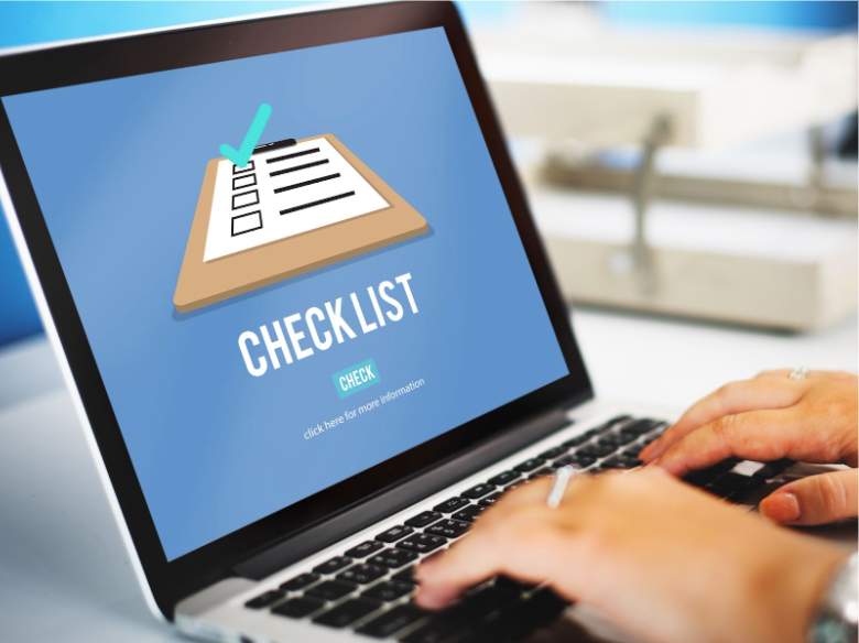 Website launch checklist on laptop screen illustrating steps for how to create a website for an artist.